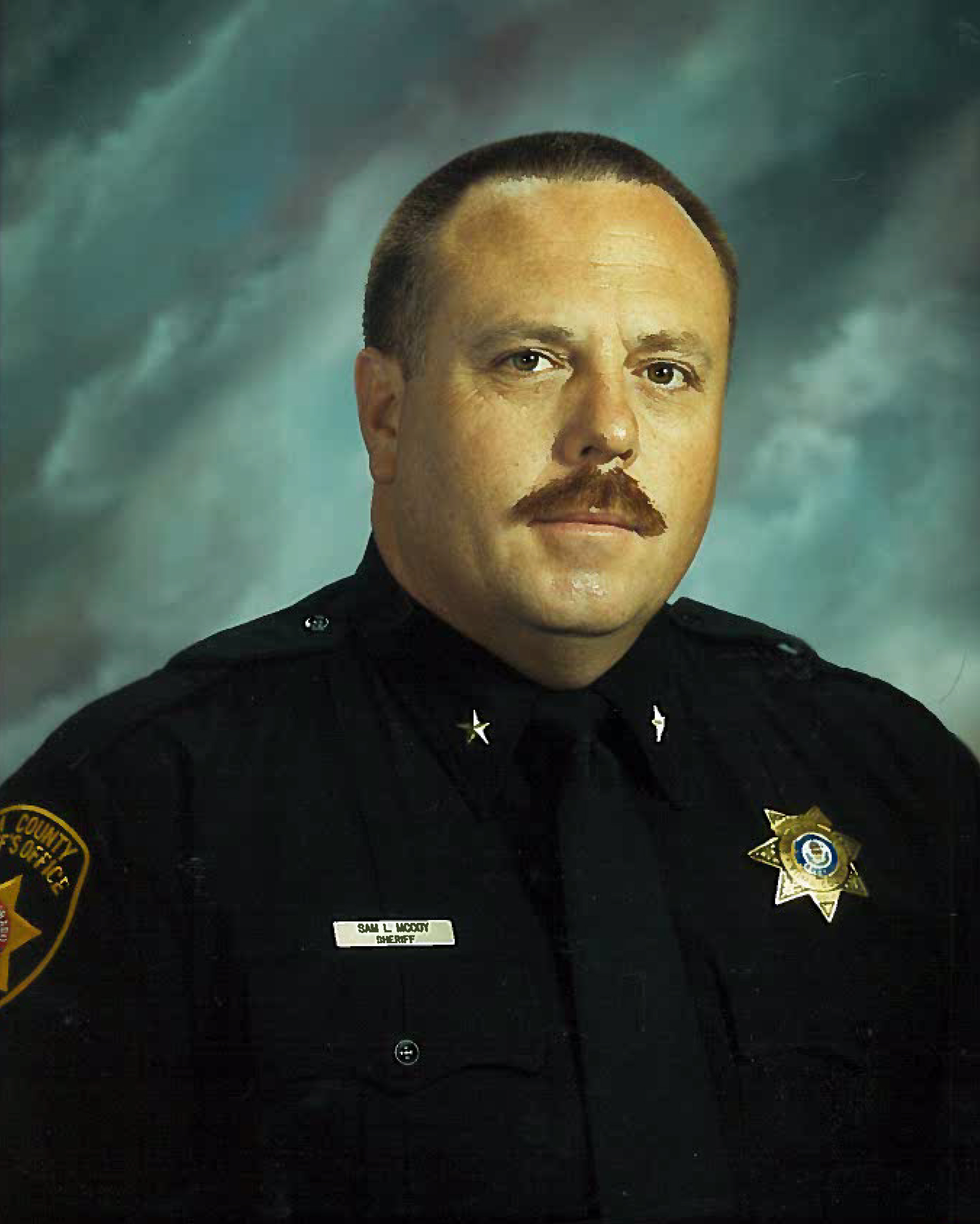 SAM L. McCOY